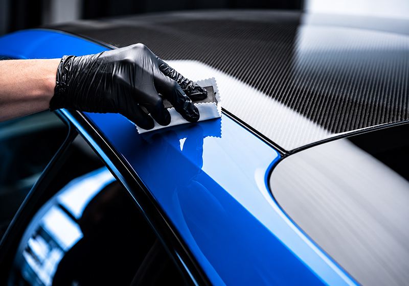 Ceramic coating being applied to a blue car