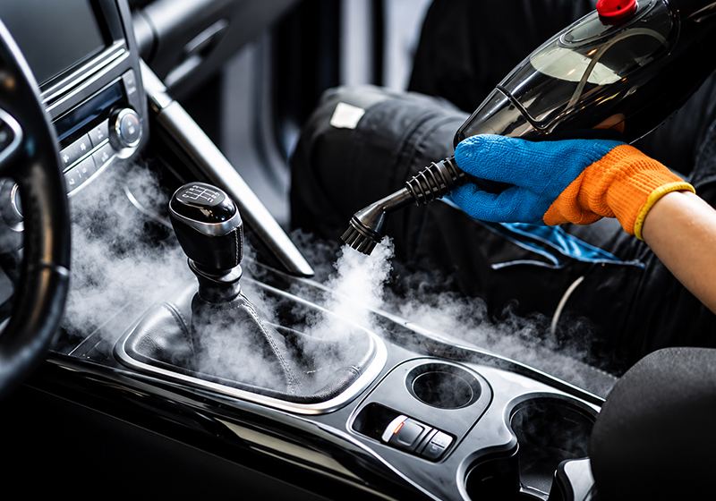 Steam cleaning a car interior centre console